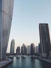 Buildings in city against clear sky