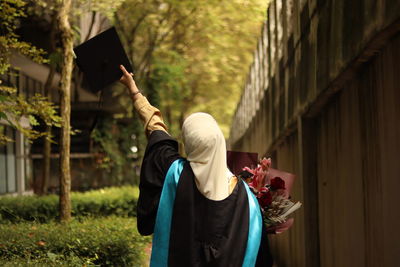 Rear view of woman who has just graduated 