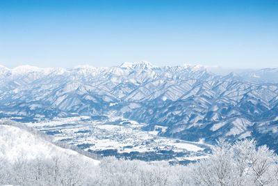 Scenic view of snowcapped mountains against clear sky