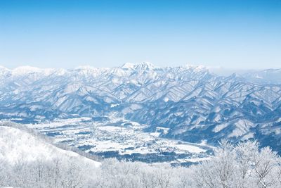 Scenic view of snowcapped mountains against clear sky