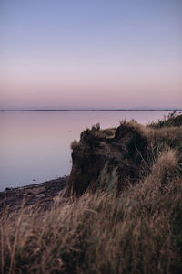 Scenic view of sea against clear sky during sunset