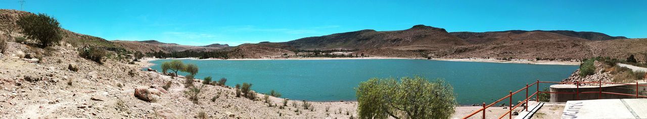 Panoramic shot of sea against clear blue sky