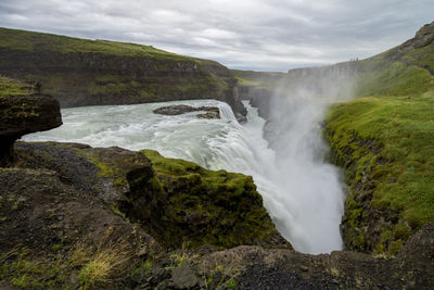 Scenic view of gullfoss against cloudy sky