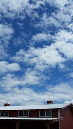 Low angle view of train against cloudy sky