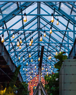 Low angle view of illuminated skylight in building