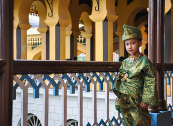 Portrait of boy standing in traditional clothing