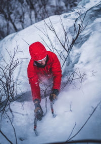 Man ice climbing on cathedral ledge in north conway, new hampshire