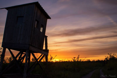 Low angle view of field against sky during sunset