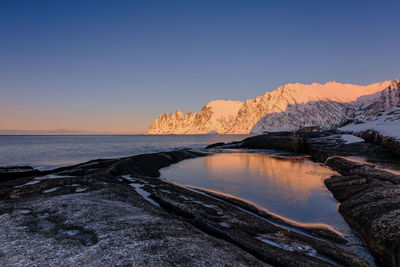 Scenic view of sea against clear sky during sunset