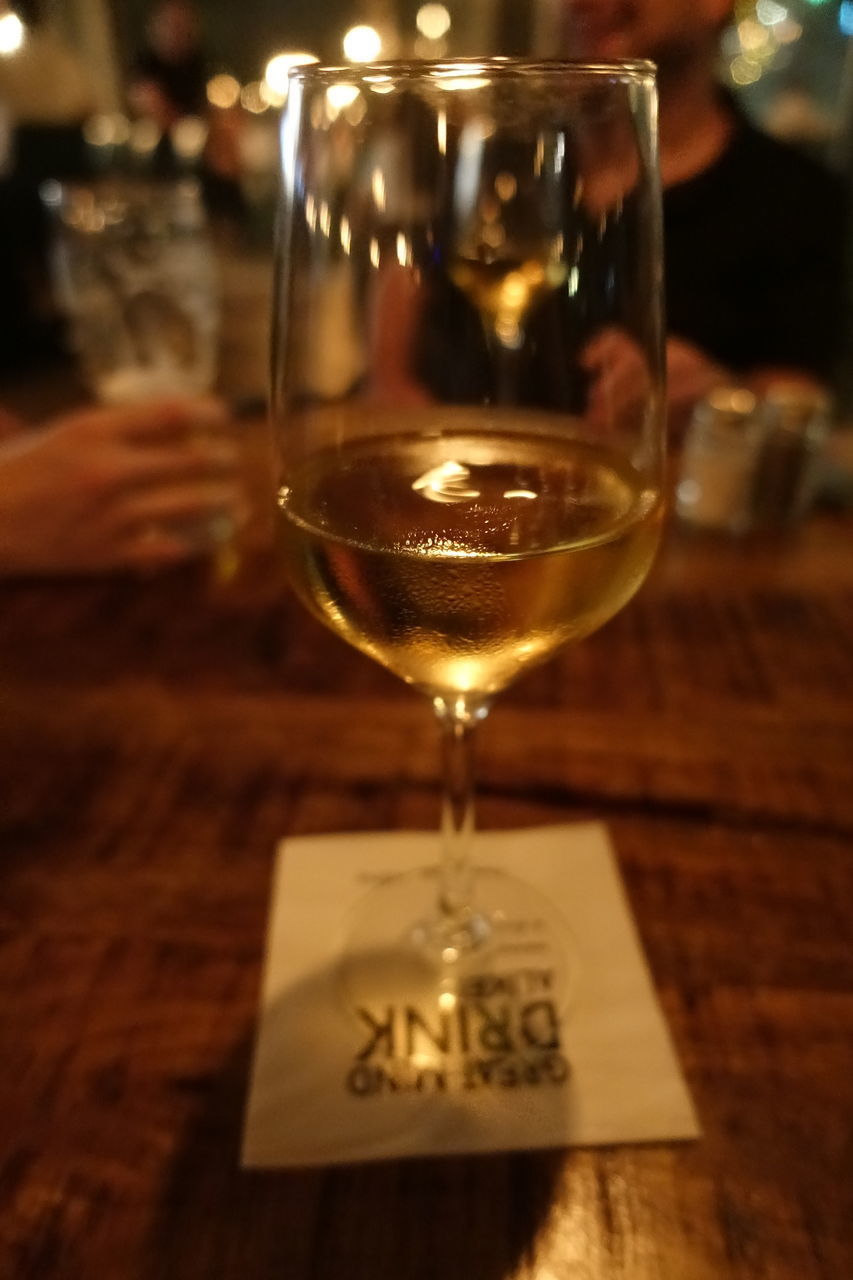 CLOSE-UP OF WINE GLASS ON TABLE IN RESTAURANT