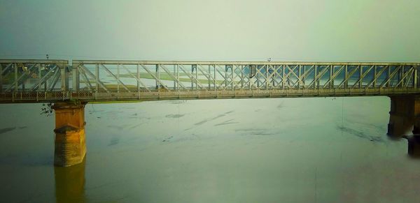 Bridge over sea against clear sky