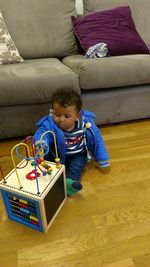 High angle view of boy sitting on floor