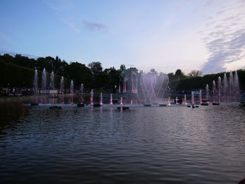 View of fountain in lake against sky