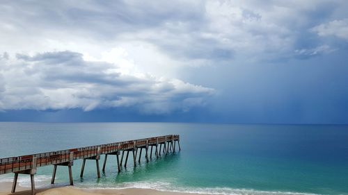 Pier over sea against sky