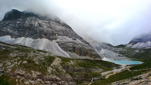 Scenic view of snow covered mountains against sky