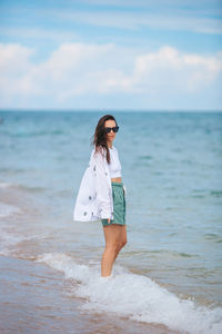 Young woman standing at beach