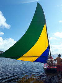 Sailboat sailing on sea against sky