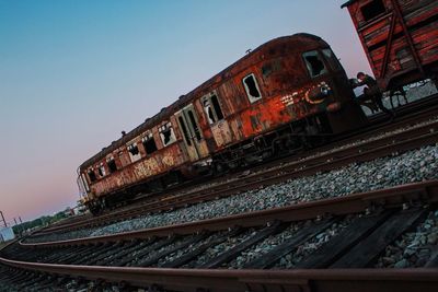 Low angle view of abandoned railroad tracks against sky