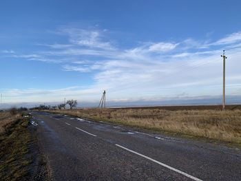Country road against sky