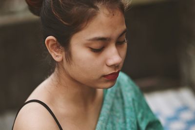 Close-up portrait of a young woman looking away