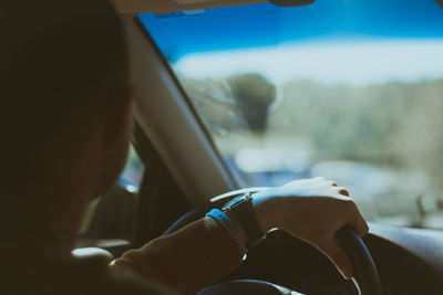 Rear view of man driving car