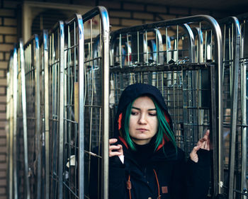 Woman wearing hooded jacket looking away