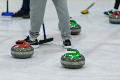 Low section of man playing curling on ice rink