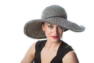 Portrait of woman wearing hat against white background