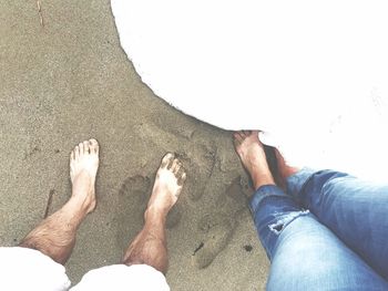 Low section of people standing on beach