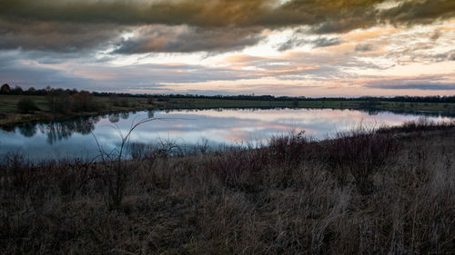 Scenic view of lake against sky during sunset