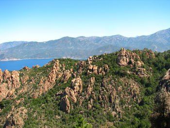 Scenic view of mountains against clear blue sky