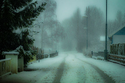 Snow covered road in city during rainy season