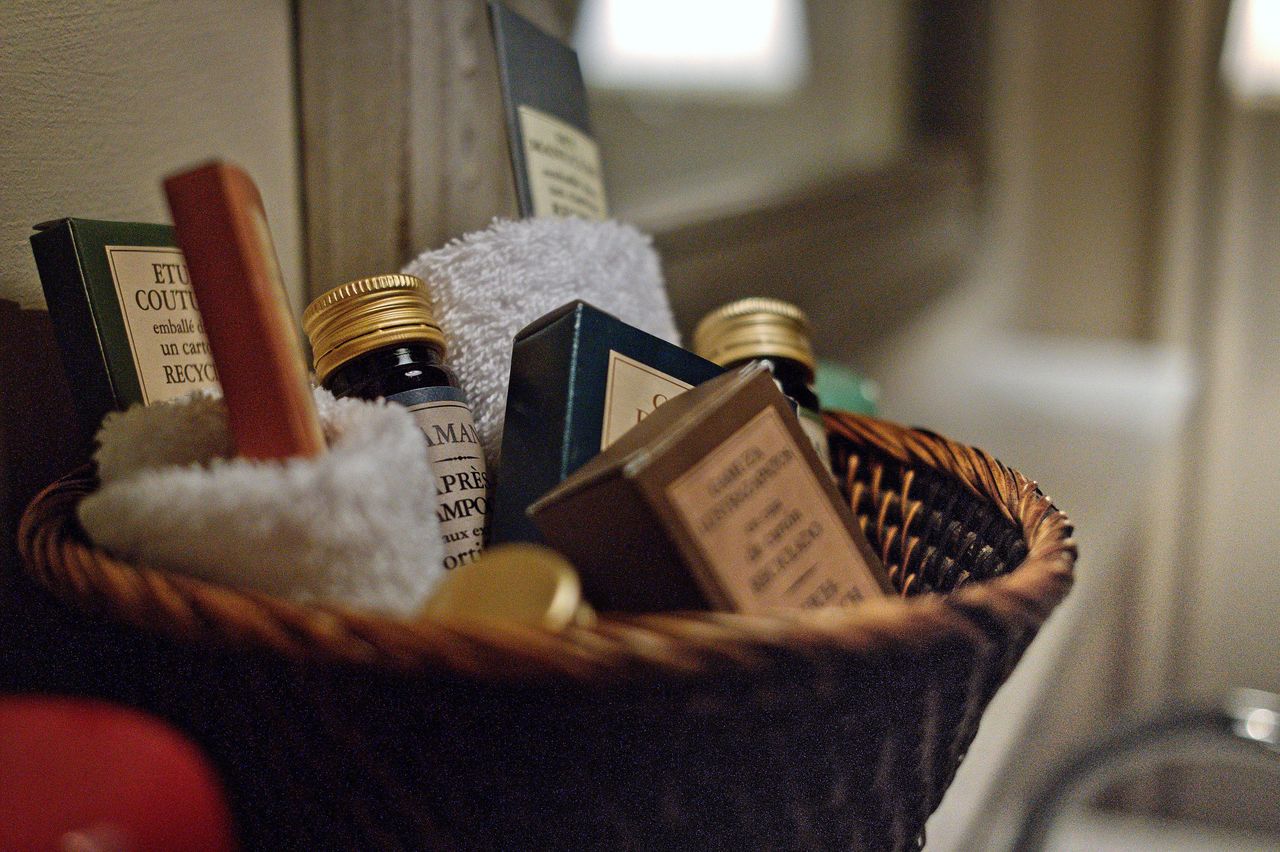 CLOSE-UP OF WINE BOTTLES ON TABLE