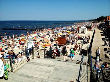 People on beach against clear sky