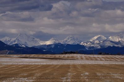 Scenic view of mountains against cloudy sky