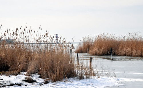 Scenic view of frozen lake against sky during winter