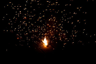 Low angle view of firework display at night