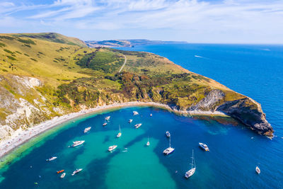 High angle view of boats on sea shore against sky