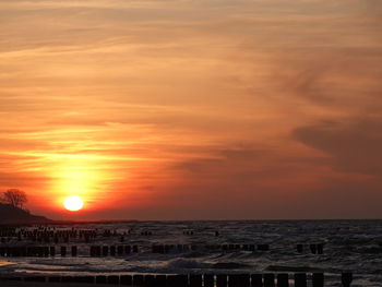 Scenic view of sea against romantic sky at sunset