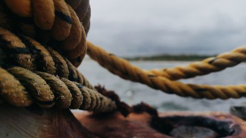 Close-up of rope tied to boat moored at harbor