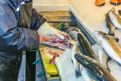 Man working at fish for sale