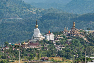 Buildings in city against mountain