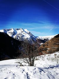 Snow covered mountains against blue sky