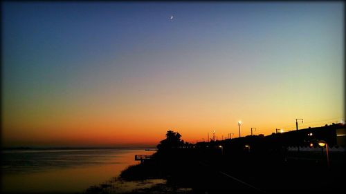 Scenic view of sea against clear sky during sunset