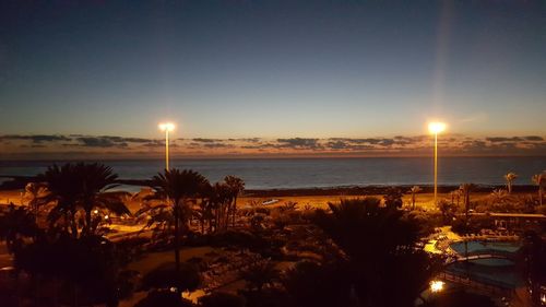 Scenic view of sea against clear sky at sunset