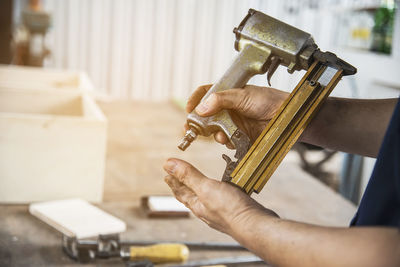 Close-up of man working on metal