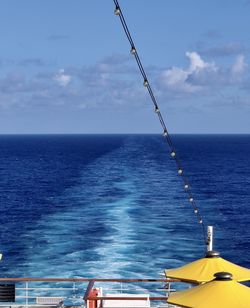 Sailboat in sea against sky