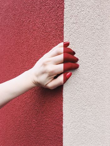 Painted woman's hand on painted wall