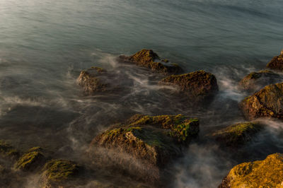 High angle view of rocks at sea shore