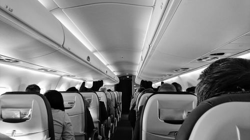 People sitting on seats in airplane